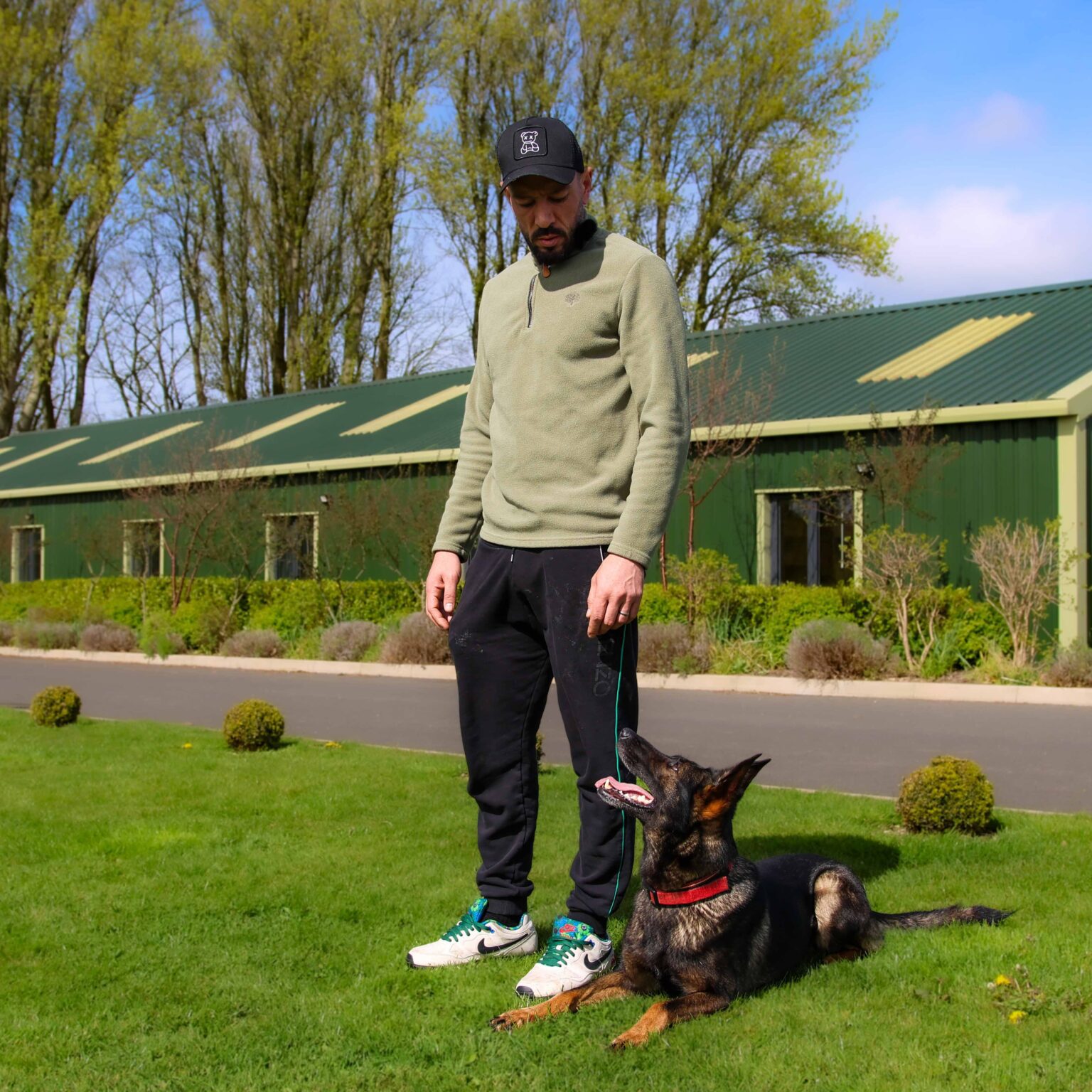 Taz with a German Shepherd lying at his feet on the training field